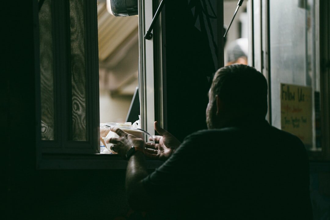 person reading old letters by window